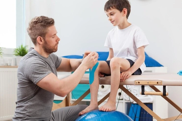 Precision Podiatry specialist treating young patient's leg alignment in Alma, MI