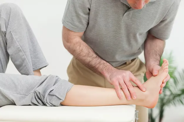 Doctor evaluating patient's foot alignment and ankle mobility at Precision Podiatry in Alma, MI