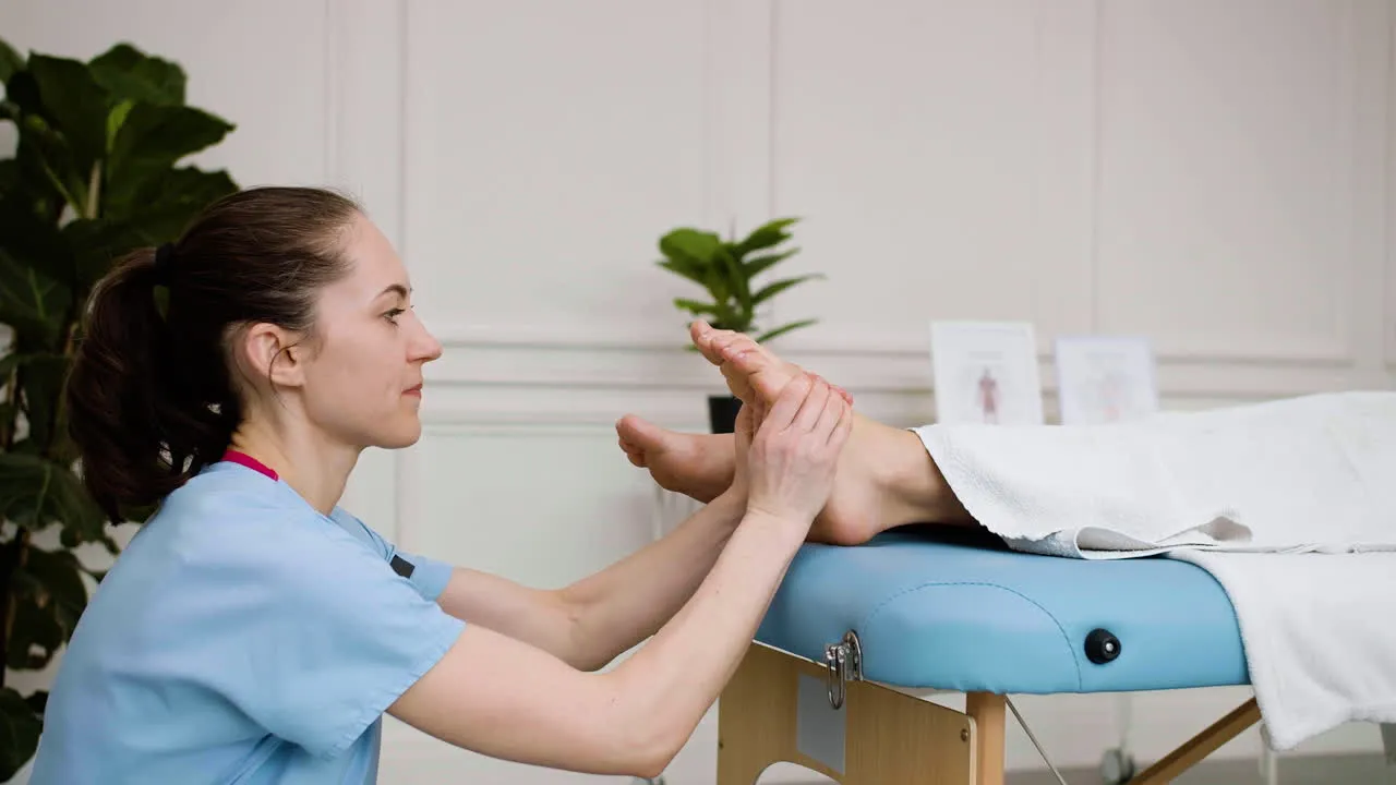 Podiatrist evaluating patient foot sole and plantar pressure for custom orthotics at Precision Podiatry in Alma