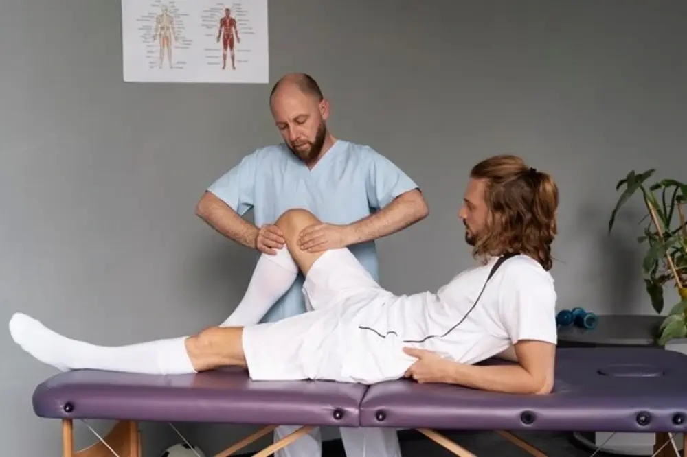Podiatrist assessing patient leg alignment for custom orthotics at Precision Podiatry in Alma