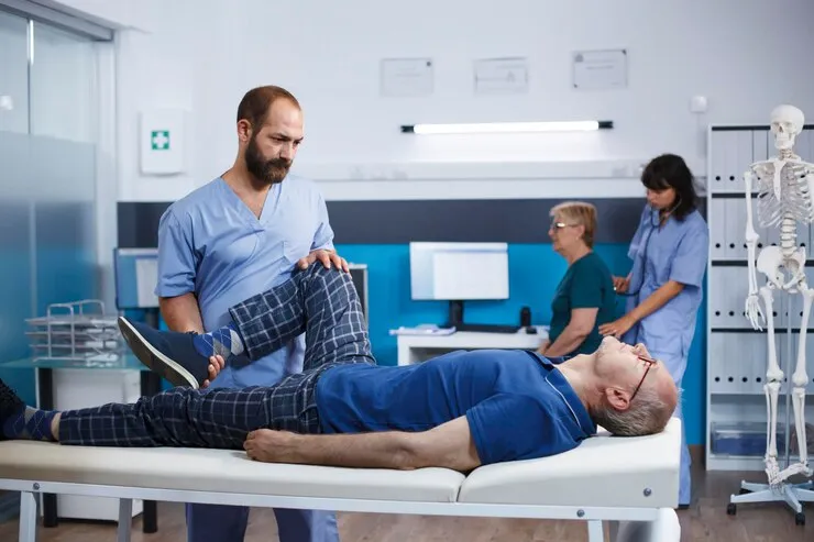 Podiatrist evaluating patient leg mobility for custom orthotics fitting at Precision Podiatry in Alma
